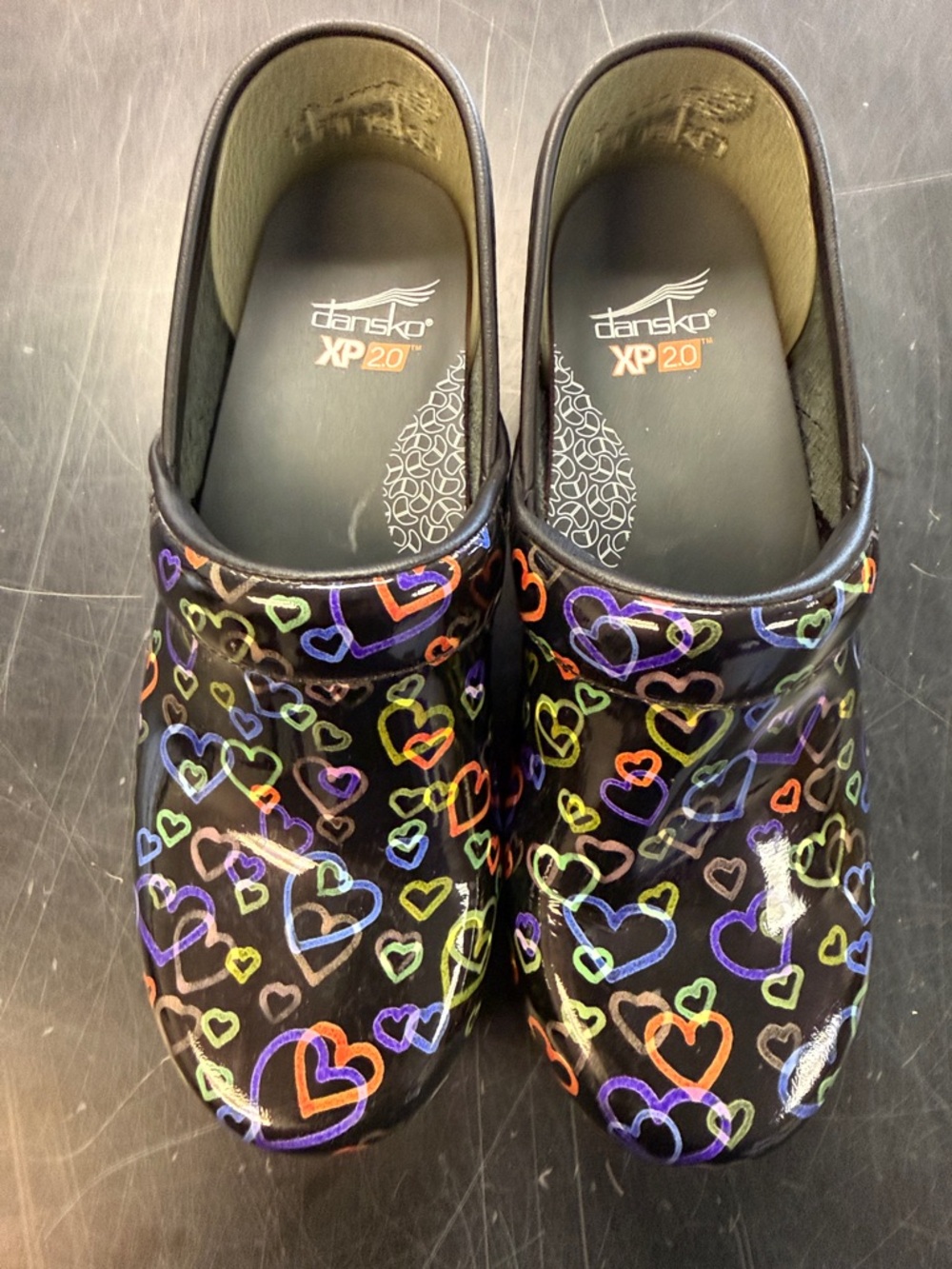 Dansko Black Patent Clogs with Multicolor Heart Print